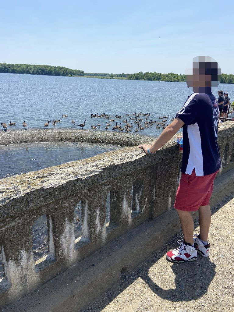 Clients feeding birds and fish at Pymatuning Lake during addiction recovery at Alpine Springs